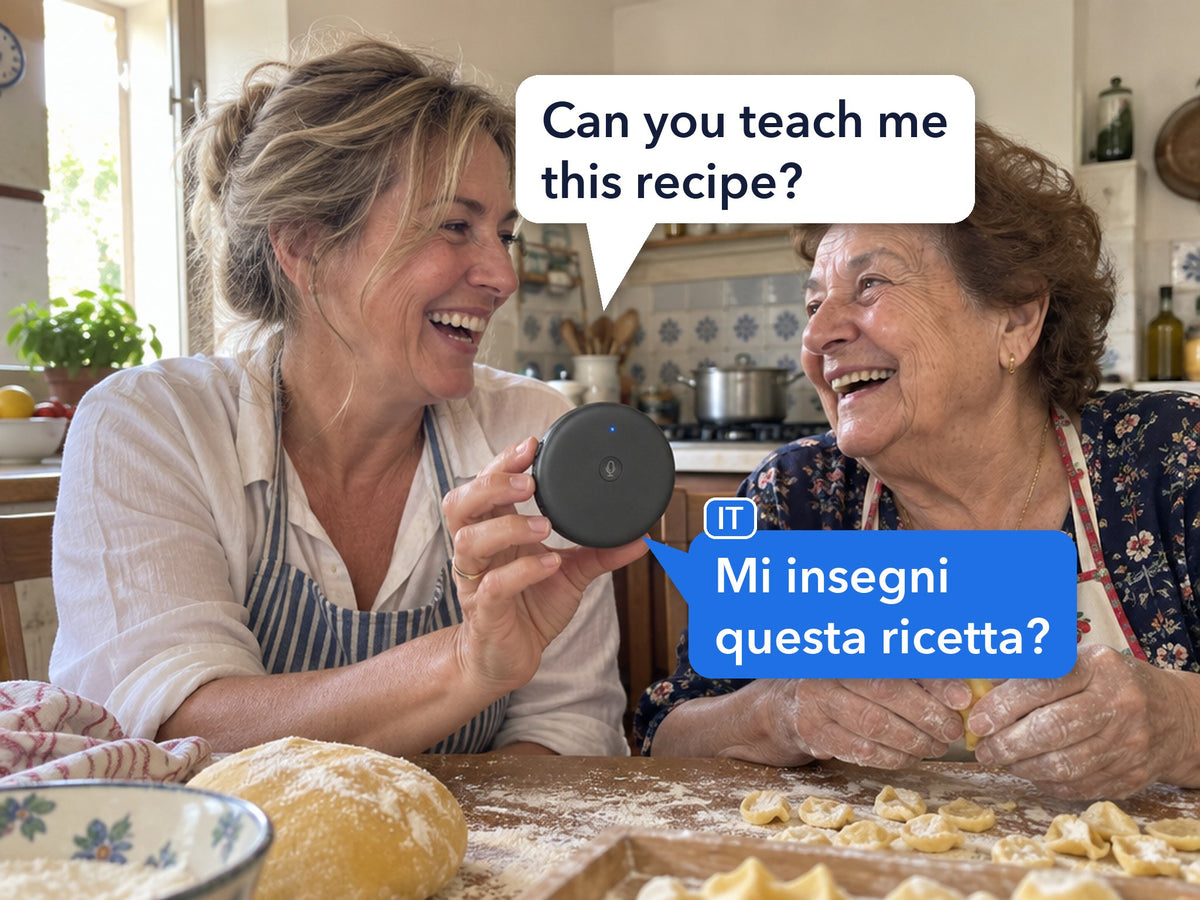An American woman and her Italian mother-in-law laugh while making pasta; she holds the ECDF translator between them, her English question shown with its Italian translation in speech bubbles